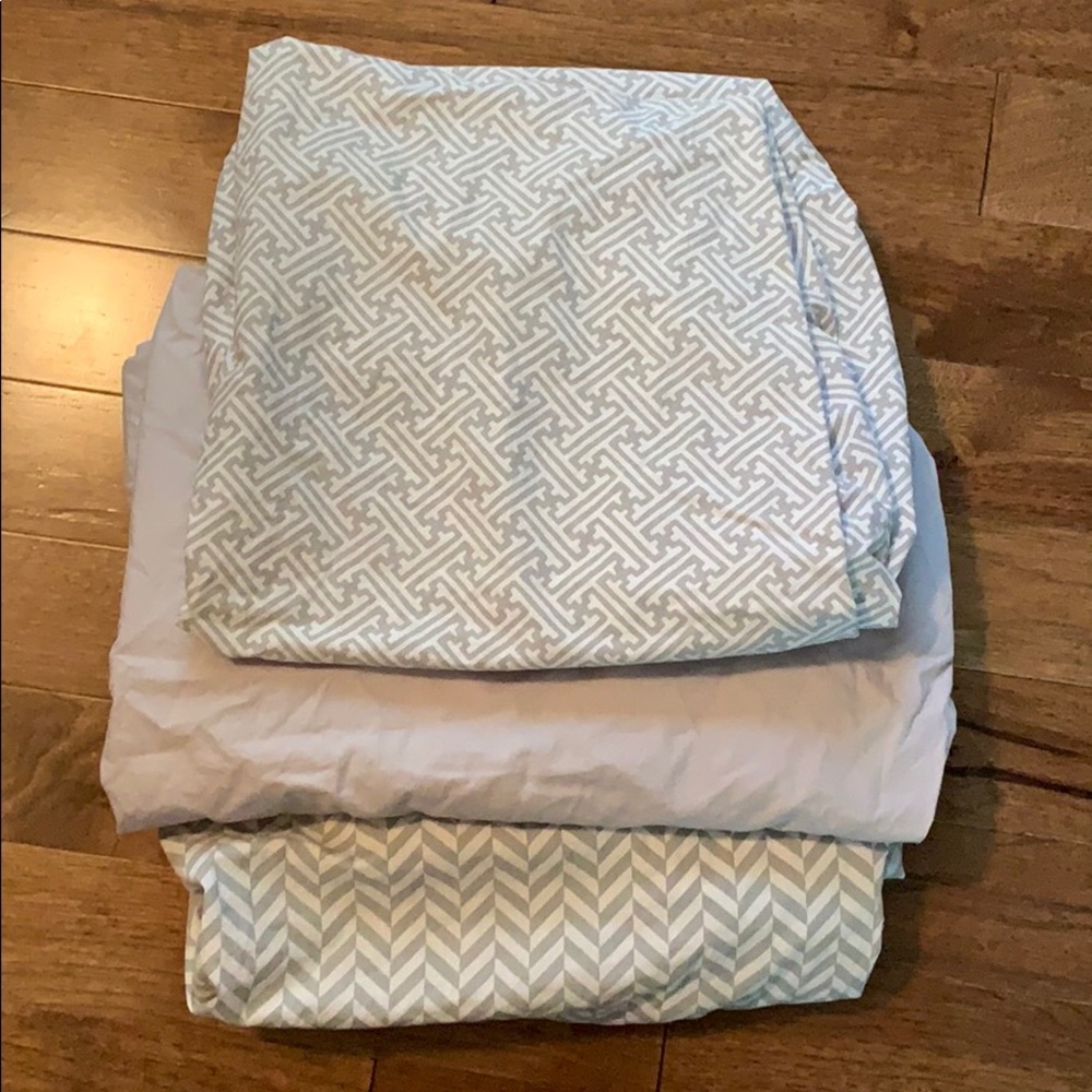 3 gray and white crib sheets